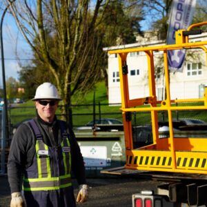 Cooper Equipment Rentals employee stood next to equipment