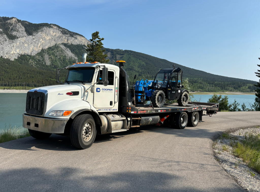 Cooper Equipment Rentals delivery truck with equipment in the back.
